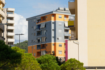 A modern orange condominium with clean lines and large windows in an Albanian seaside town. Great for holiday rentals, foreign buyers, long-term leasing, and urban investment opportunities.