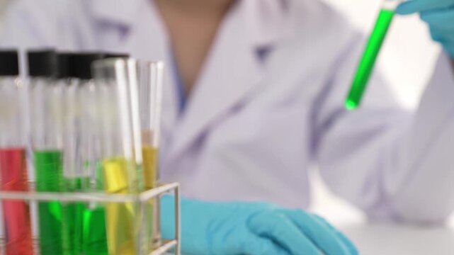 Laboratory researcher develop new medicine or cure use colorful chemical liquid in lab tube. Technological advance of healthcare with scientific or chemistry expertise and laboratory equipment. Rigid.