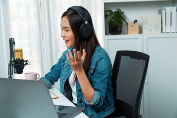 Host channel of young beautiful Asian wearing jeans creative broadcaster talking in online broadcast explaining to promote marketing or consultant in daily life with listener at studio. Stratagem.
