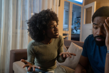 relationship difficulties, conflict and people concept - unhappy african american couple having argument at home