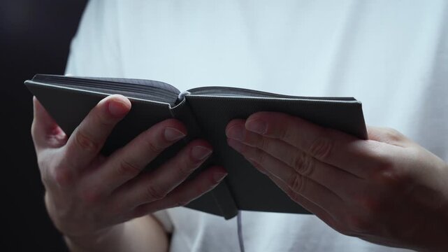 Religion and culture.
Reading a prayer from the Bible.
A Christian with a Bible in his hands reads a prayer.
God, church, prayer, book, Jesus, Christian