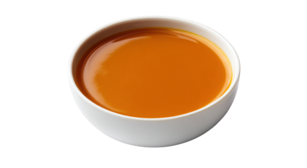 A bowl of yellow liquid sits on a white background