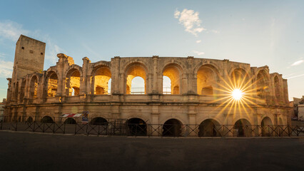 Roman amphitheater with sunburst in Arles, France. Sunburst bursting through an arch in the Roman amphitheater in the provencal town of Arles, France.  © Patrick