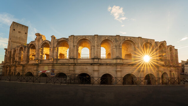Roman amphitheater with sunburst in Arles, France. Sunburst bursting through an arch in the Roman amphitheater in the provencal town of Arles, France. 