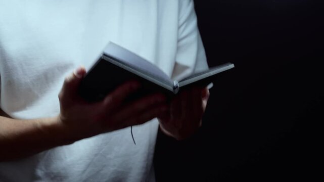 An open Bible in the hands of a religious person.
Bible texts for prayer.