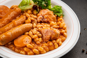 Casule meat with beans in sauce sausages, pork main course tasty snack fresh delicious gourmet food table background rustic food top view copy space
