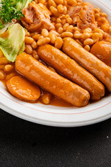 Casule meat with beans in sauce sausages, pork main course tasty snack fresh delicious gourmet food table background rustic food top view copy space