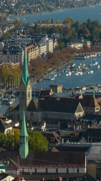 sunny day flight over zurich city center famous church towers aerial panorama 4k vertical timelapse switzerland 