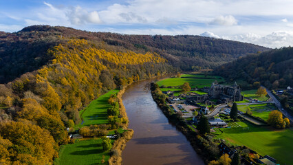 Aerial view of the historic ruins of Tintern Abbey on the River Wye in autumn