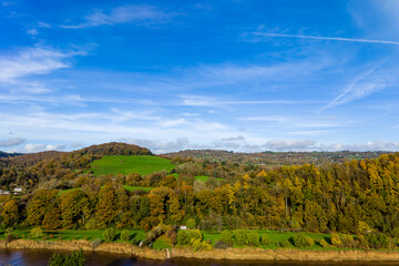 Naklejka premium Vibrant autumn colours on the forested hillsides of the Wye Valley, Monmouthshire