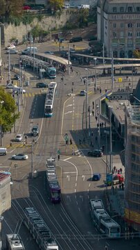 sunny day flight over zurich city center tram traffic bridge street station aerial panorama 4k vertical timelapse switzerland 