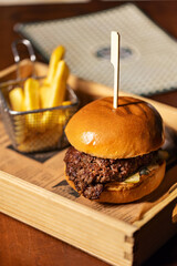 Juicy beef burger served with crispy fries
Classic brioche bun burger with grilled beef patty
Gourmet beef burger meal with fries in a wooden tray