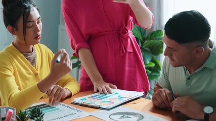 Top view of manager writing idea on sticky notes and explain idea about web design. Professional marketing team or programmer brainstorming idea while looking at tablet with color palette. Symposium.