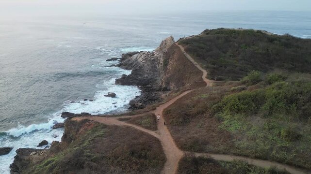 Drone Pass Over a Remote Walkway Surrounded by Dry Coastal Mountains in Punta Cometa Mazunte
