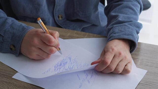 A man sits at a desk, writing something with a pen on a white sheet of paper.
A screenwriter writes a text on a piece of paper.
Education and training, a smart guy writes something with a pen.
Writing