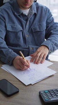 Journalism and paperwork.
A man works in an office and signs important documents.
An editor corrects text on a white sheet of paper.
Calligraphy and handwriting