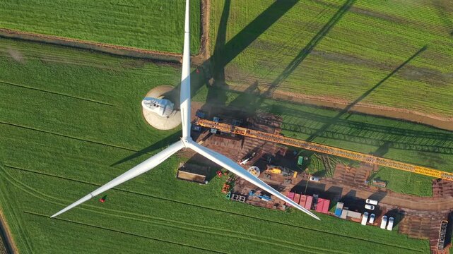 Wind Turbine Construction with Crane Installing Rotor Blades
