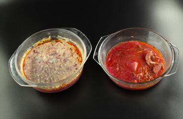 Two transparent glass bowls filled with beet soup stand side by side on a dark background. One container shows fresh red soup with visible meat and vegetables, while the other displays spoiled soup 