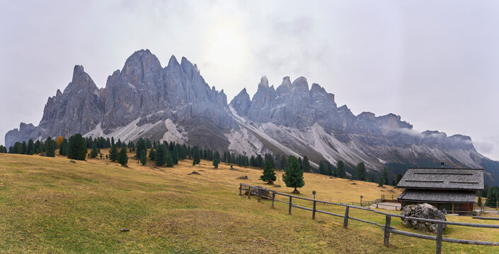 Panoramic view on the sawtooth-shaped Odles Group peaks that rise up above alpine meadow, as seen in the Adolf Munkel hiking trail. Dramatic and unforgettable landscape in the Funes Valley, Dolomites.