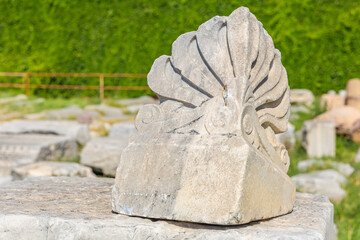 Ancient marble architectural fragment in outdoor historical site. Authentic ancient Smyrna ruins in Izmir, Turkey