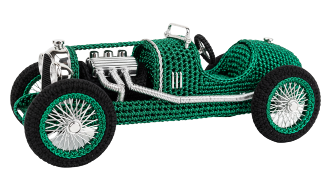 Vintage race car design crafted from deep emerald green metallic yarn showcases detailed craftsmanship and nostalgic allure