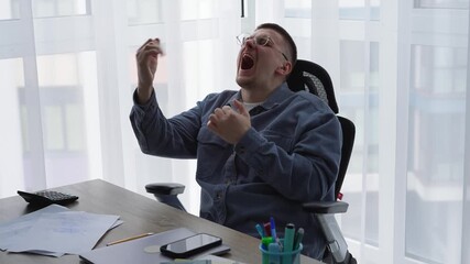 A person's career growth.
A manager in an office is happy about good sales and a deal.
A man in glasses is yelling at someone and enjoying himself at work.
Work, happy, dancing, emotions, career