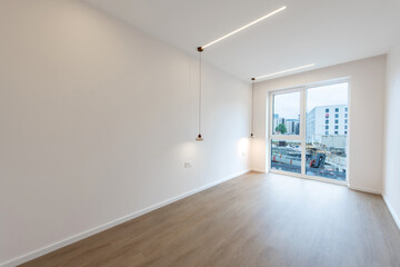 Modern Empty Room with Wooden Floor and Large Window Overseeing Construction