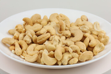 Cashews displayed on a white plate ready for snacking