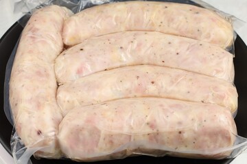 Sausages ready for frying on a black skillet