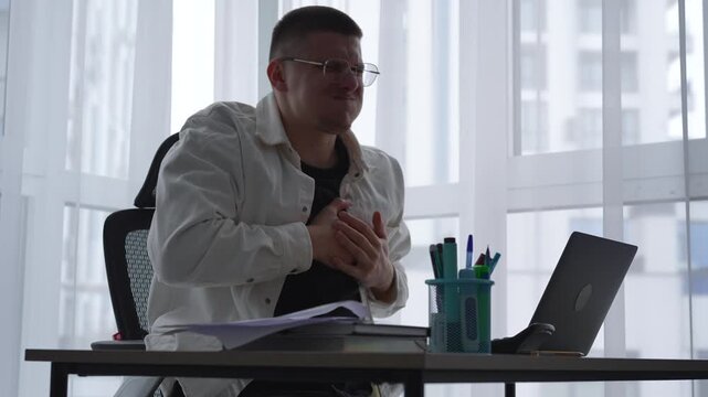 Heart problems in a firefighter.
A person is having a heart attack.
Cardiac problems in a person.
Pain, heart, discomfort, work, laptop, office