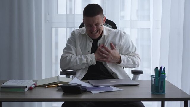 Chest pain in a person working in an office at a computer.
Cardiological problems and sudden heart attack.
Panic attack.
The person has heart pain.