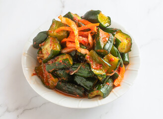 Spicy cucumber kimchi. This dish adds a delicious touch of Korea to any meal, perfect for blogs.