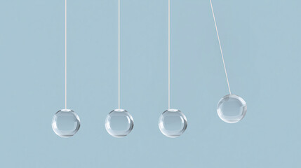 Newton cradle balls in motion against a light blue background  
