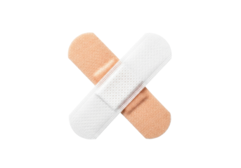 Two flesh-toned adhesive medical bandages with white sterile pads and ventilation holes, crossed 'X' shape, on a transparent background. Concept of first aid and healthcare support