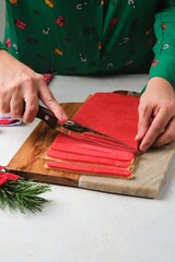 Step-by-step preparation of Candy Cane shortbread cookies in Christmas decor on a light concrete background. Merry Christmas! Traditional Christmas treats