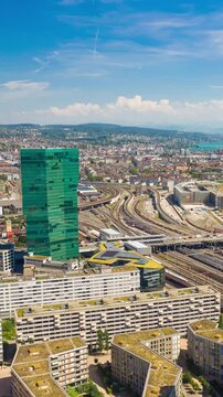 flight over zurich city train station traffic sunny day aerial vertical panorama 4k timelapse switzerland 