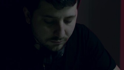 nighttime recording specialist at work, quiet male sound engineer preparing for live podcast session