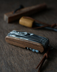 Multi-tool pocket knife and fire starter in the background