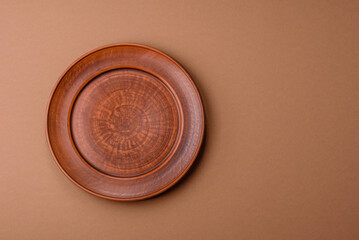 An empty round ceramic plate on a table, kitchenware. An empty plate