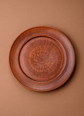 An empty round ceramic plate on a table, kitchenware. An empty plate