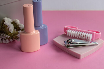Nail care accessories and pastel nail polish bottles illustrating manicure beauty, self care, and wellness at home or professional spa