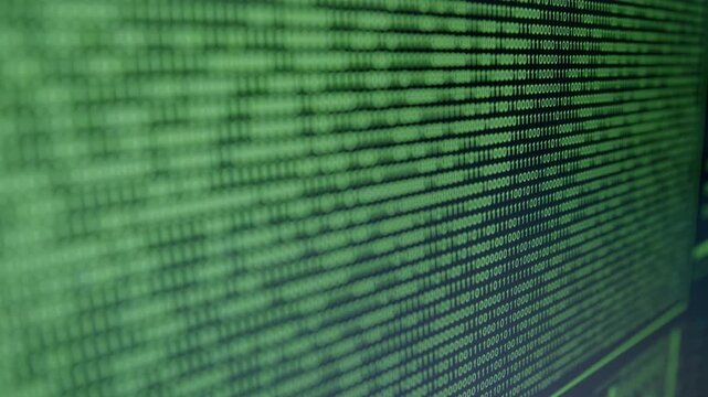 Close-up view of cascading binary code on a digital screen, showcasing a hacker cyber attack, with gradual zoom in revealing intricate data patterns and flow