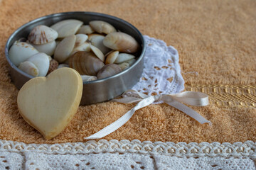 Heart shaped soap and seashells creating a tranquil setting for self care, wellness, and a relaxing spa experience with natural beauty elements at home