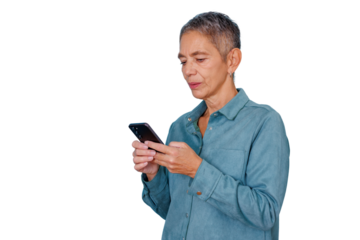Senior woman with grey hair standing, concentrating on her smartphone, engaging with modern mobile technology and communication