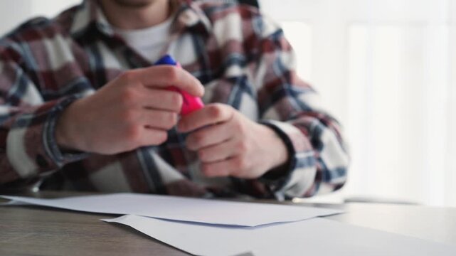 A person draws lines on a white sheet of paper with a marker.
Using a highlighter to work and outline text on paper.
Paperwork in a company.