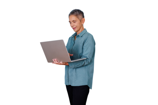 Senior woman standing, actively using a laptop, engaging with technology and managing business. Transparent background