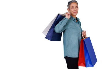 Senior woman carrying multiple retail shopping bags on shoulder and hand, enjoying consumerism and sales, transparent background