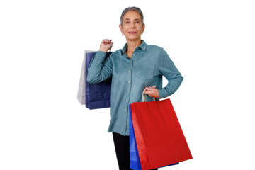 Senior woman carrying multiple shopping bags, enjoying consumerism and retail therapy, transparent background