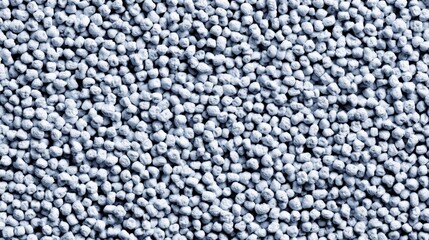 Close up view of small, irregularly shaped white granules filling the frame