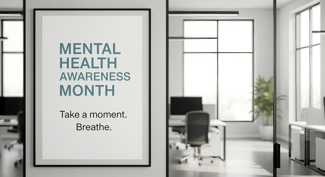 Mental Health Awareness Month poster hanging in a modern office. Workplace wellness and mindfulness concept for employee well-being and stress management.